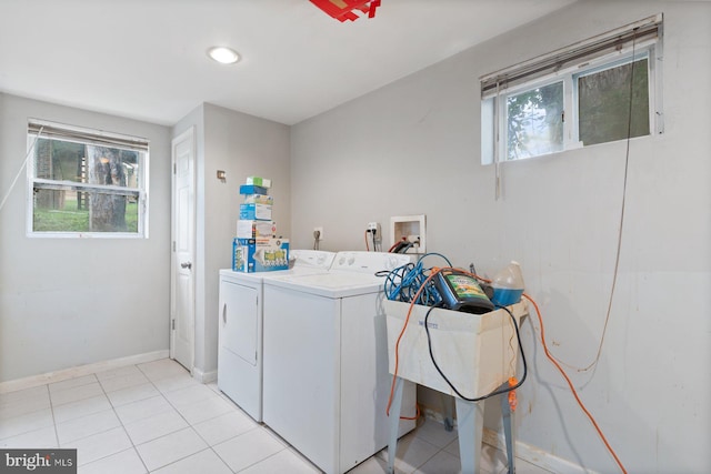 10700 Bickford Ave, Clinton, MD 20735 - laundry area featuring washer and clothes dryer, plenty of natural light, baseboards, and light tile patterned flooring