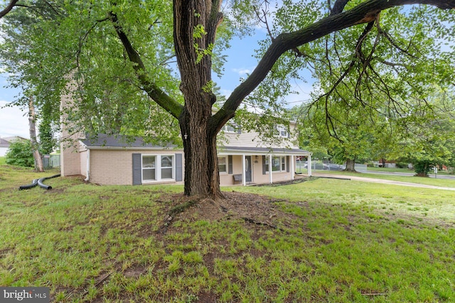10700 Bickford Ave, Clinton, MD 20735 - view of front of home with a front yard, brick siding, and a porch