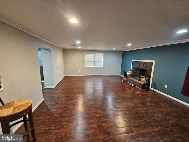 10700 Bickford Ave, Clinton, MD 20735 - unfurnished living room featuring crown molding, wood finished floors, recessed lighting, a brick fireplace, and baseboards