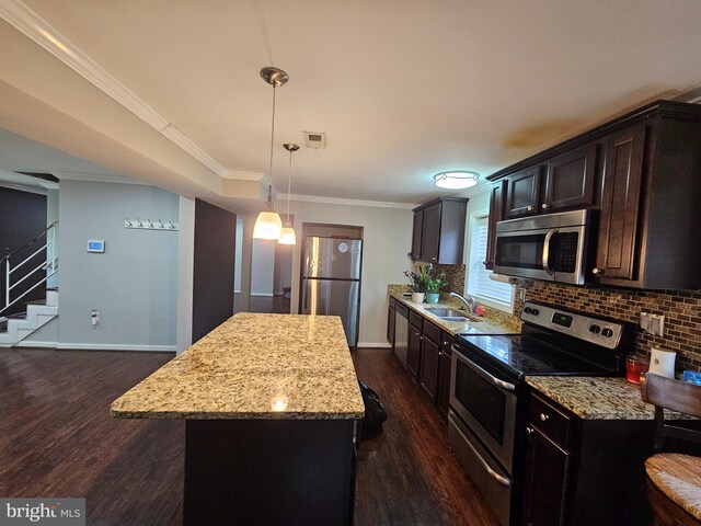 10700 Bickford Ave, Clinton, MD 20735 - kitchen with appliances with stainless steel finishes, dark wood-type flooring, a center island, baseboards, and tasteful backsplash