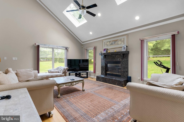 20008 Giantstep Ter, Gaithersburg, MD 20886 - living room featuring a skylight, crown molding, a fireplace, a ceiling fan, and high vaulted ceiling