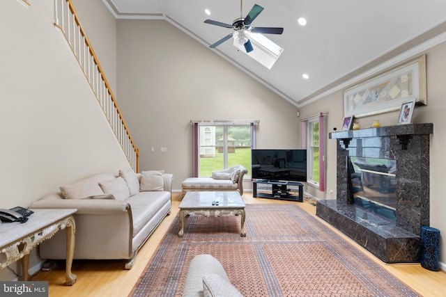 20008 Giantstep Ter, Gaithersburg, MD 20886 - living area featuring wood finished floors, ornamental molding, ceiling fan, stairway, and a skylight