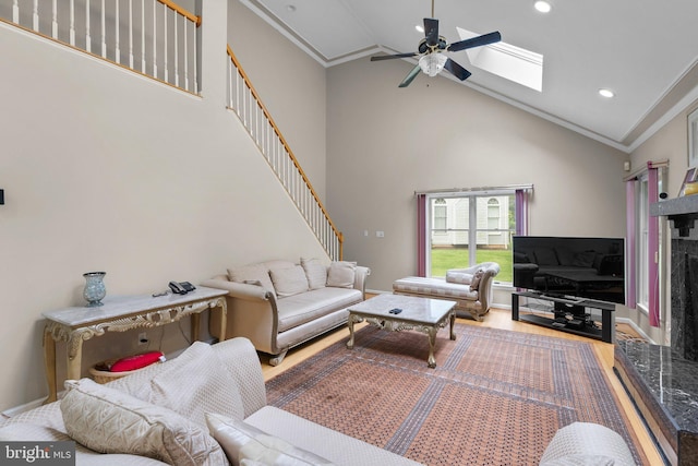 20008 Giantstep Ter, Gaithersburg, MD 20886 - living area with ornamental molding, a skylight, a ceiling fan, high vaulted ceiling, and wood finished floors