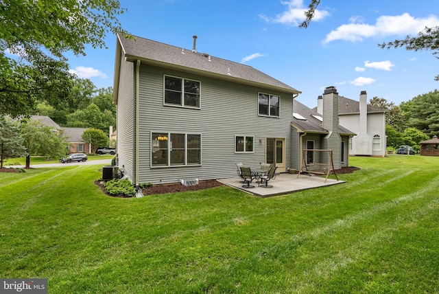 20008 Giantstep Ter, Gaithersburg, MD 20886 - rear view of house featuring central AC, a lawn, a patio area, and roof with shingles