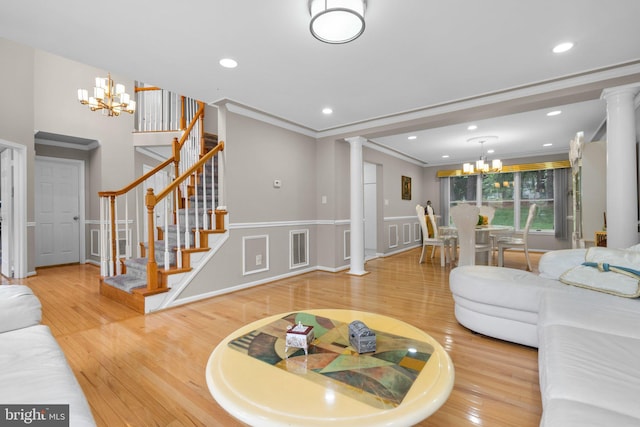 20008 Giantstep Ter, Gaithersburg, MD 20886 - living area with a chandelier, ornate columns, wood finished floors, stairway, and crown molding