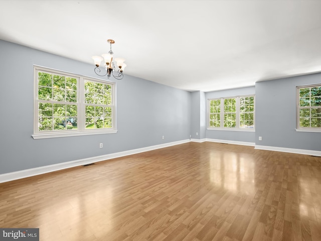 7301 Eden Brook Dr Unit A-1, Columbia, MD 21046 - spare room featuring a chandelier and wood finished floors
