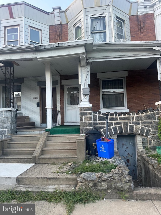 5823 Filbert St, Philadelphia, PA 19139 - doorway to property featuring a porch and brick siding