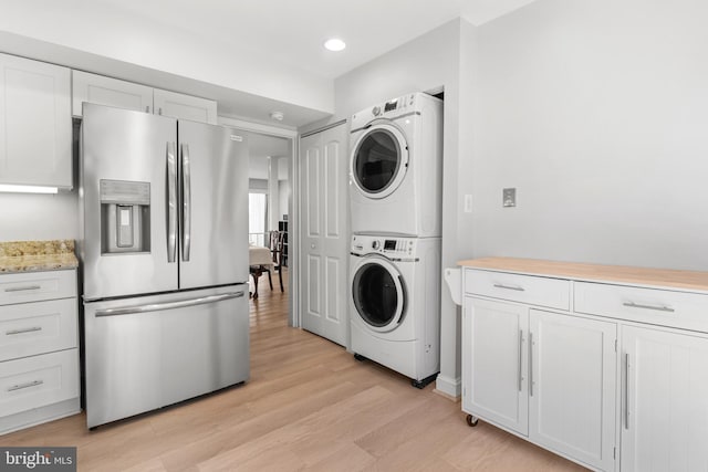 7374 Park Heights Ave, Baltimore, MD 21208 - laundry area featuring stacked washer and clothes dryer, light wood-style flooring, and recessed lighting