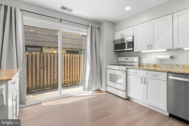 7374 Park Heights Ave, Baltimore, MD 21208 - kitchen featuring appliances with stainless steel finishes, wood counters, white cabinetry, recessed lighting, and light wood-style floors