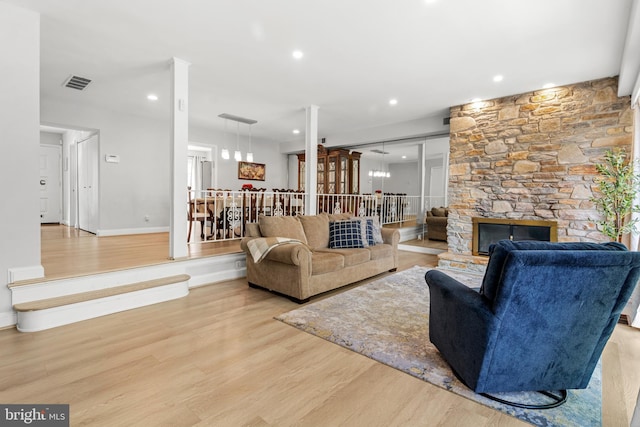 7374 Park Heights Ave, Baltimore, MD 21208 - living area featuring wood finished floors, a stone fireplace, recessed lighting, and baseboards