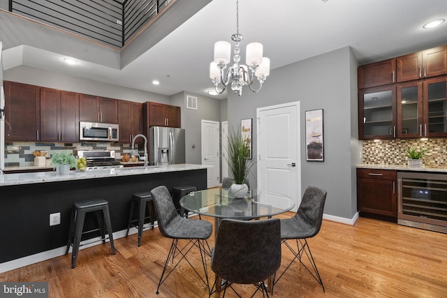 1423 1st St NW Unit B, Washington, DC 20001 - dining room featuring beverage cooler, a chandelier, recessed lighting, light wood-style floors, and baseboards