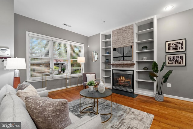 1423 1st St NW Unit B, Washington, DC 20001 - living room featuring wood finished floors, baseboards, a fireplace with flush hearth, and built in features
