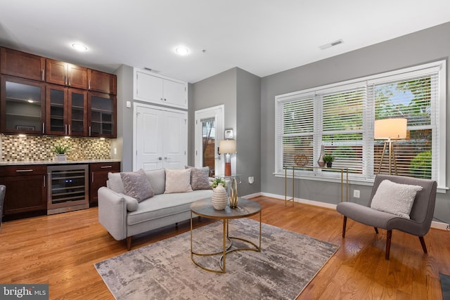 1423 1st St NW Unit B, Washington, DC 20001 - living room with beverage cooler, a dry bar, light wood-style flooring, and baseboards