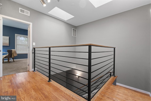 1423 1st St NW Unit B, Washington, DC 20001 - hallway featuring a skylight, an upstairs landing, wood finished floors, and baseboards