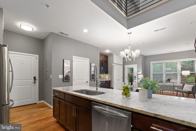 1423 1st St NW Unit B, Washington, DC 20001 - kitchen featuring stainless steel appliances, a sink, a chandelier, light wood finished floors, and dark brown cabinetry
