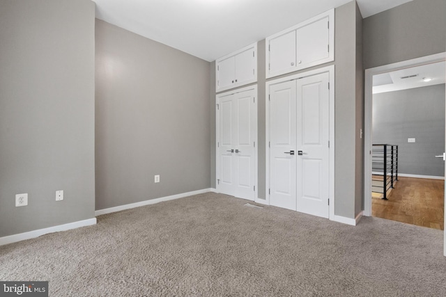 1423 1st St NW Unit B, Washington, DC 20001 - unfurnished bedroom with multiple closets, carpet floors, and baseboards