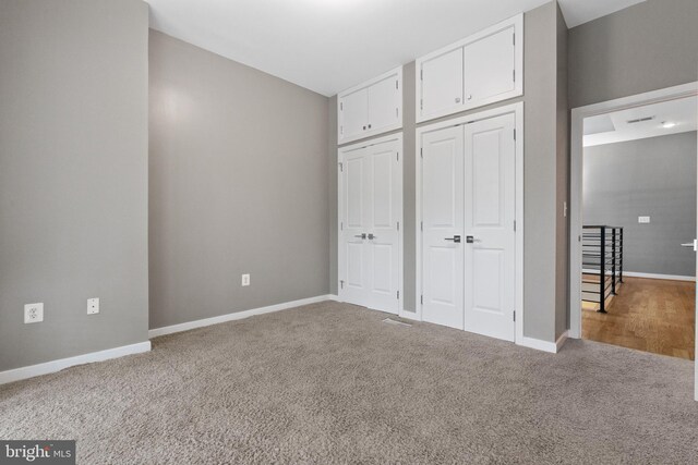 1423 1st St NW Unit B, Washington, DC 20001 - unfurnished bedroom with multiple closets, carpet floors, and baseboards