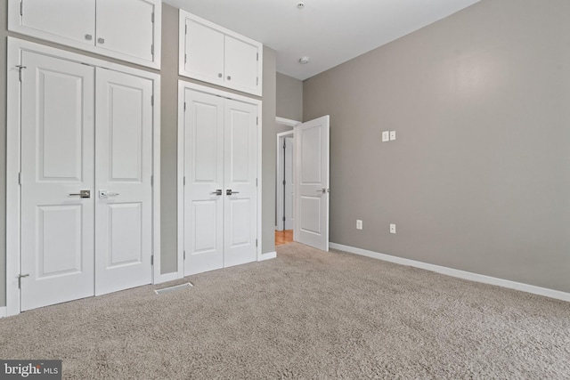 1423 1st St NW Unit B, Washington, DC 20001 - unfurnished bedroom featuring carpet, multiple closets, and baseboards