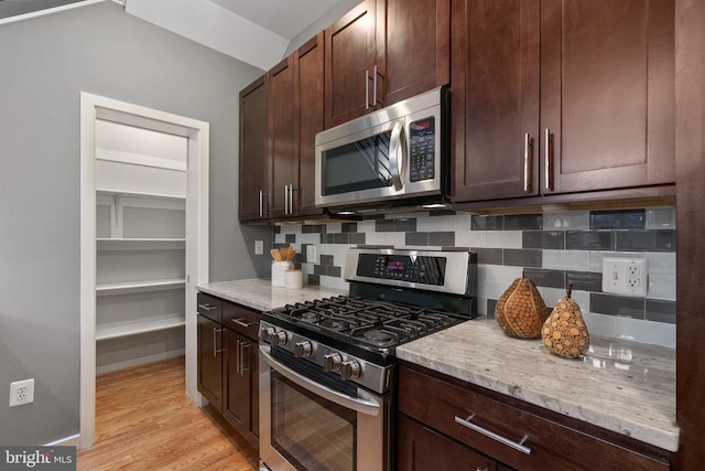 1423 1st St NW Unit B, Washington, DC 20001 - kitchen with stainless steel appliances, tasteful backsplash, light stone counters, dark brown cabinetry, and light wood-style flooring