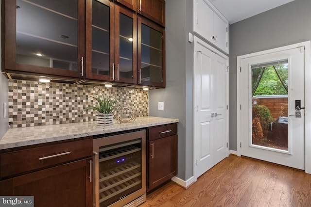 1423 1st St NW Unit B, Washington, DC 20001 - bar with wine cooler, light wood-style floors, decorative backsplash, and baseboards
