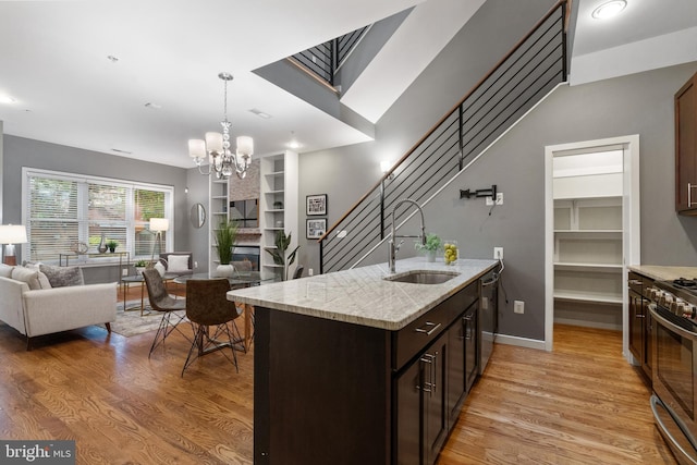1423 1st St NW Unit B, Washington, DC 20001 - kitchen featuring a sink, open floor plan, appliances with stainless steel finishes, and light wood-type flooring