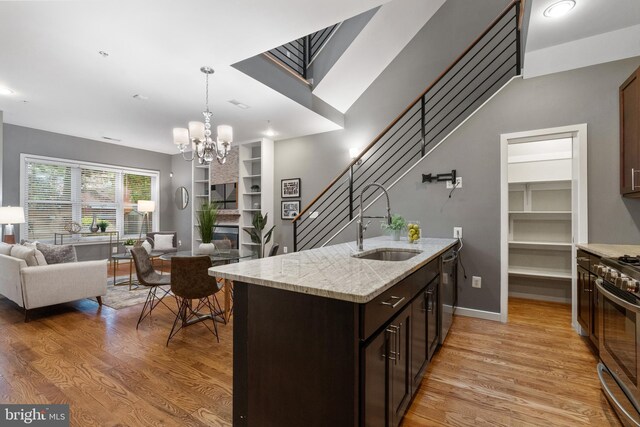 1423 1st St NW Unit B, Washington, DC 20001 - kitchen featuring a sink, open floor plan, appliances with stainless steel finishes, and light wood-type flooring