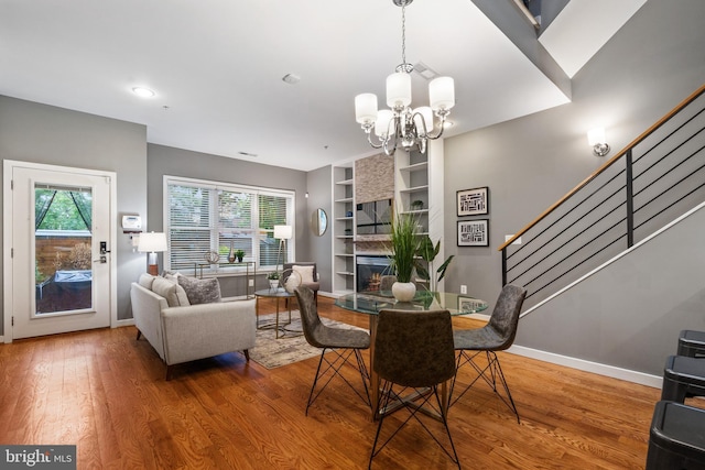 1423 1st St NW Unit B, Washington, DC 20001 - dining space with wood finished floors, a chandelier, stairs, and baseboards