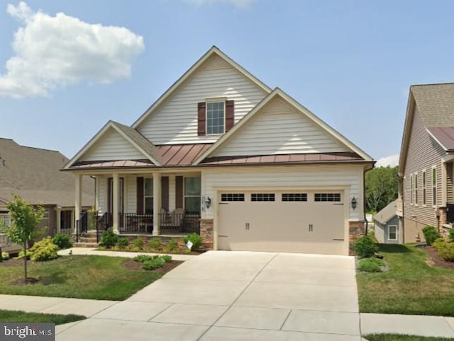 3218 Thornapple Dr, Frederick, MD 21704 - view of front facade featuring a standing seam roof, covered porch, a front yard, driveway, and stone siding