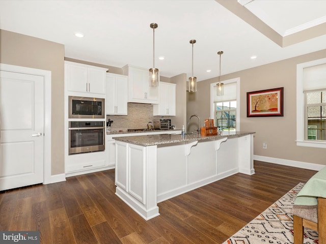 3218 Thornapple Dr, Frederick, MD 21704 - kitchen featuring oven, built in microwave, light stone counters, tasteful backsplash, and plenty of natural light