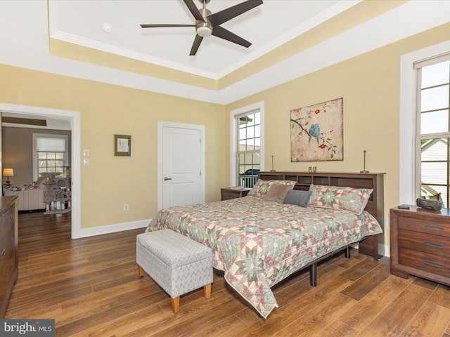 3218 Thornapple Dr, Frederick, MD 21704 - bedroom featuring wood finished floors, a tray ceiling, baseboards, multiple windows, and crown molding