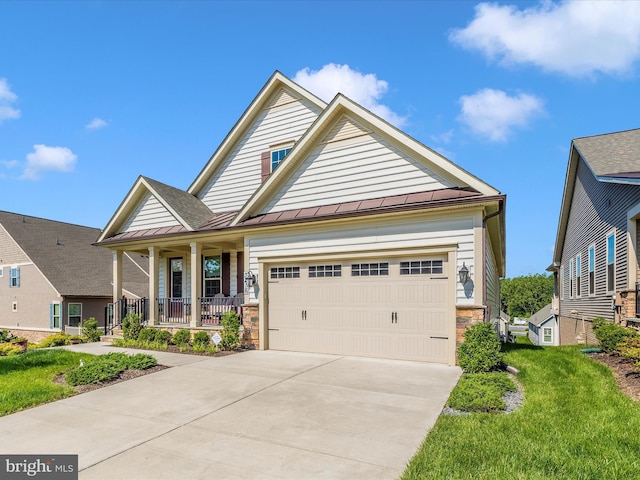 3218 Thornapple Dr, Frederick, MD 21704 - view of front facade with covered porch, a standing seam roof, metal roof, a garage, and stone siding