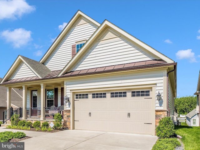 3218 Thornapple Dr, Frederick, MD 21704 - view of front facade featuring covered porch, a standing seam roof, driveway, metal roof, and stone siding