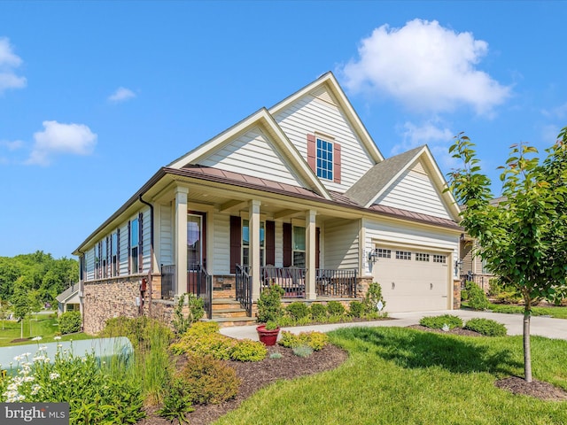 3218 Thornapple Dr, Frederick, MD 21704 - view of front of home with a standing seam roof, stone siding, covered porch, concrete driveway, and metal roof