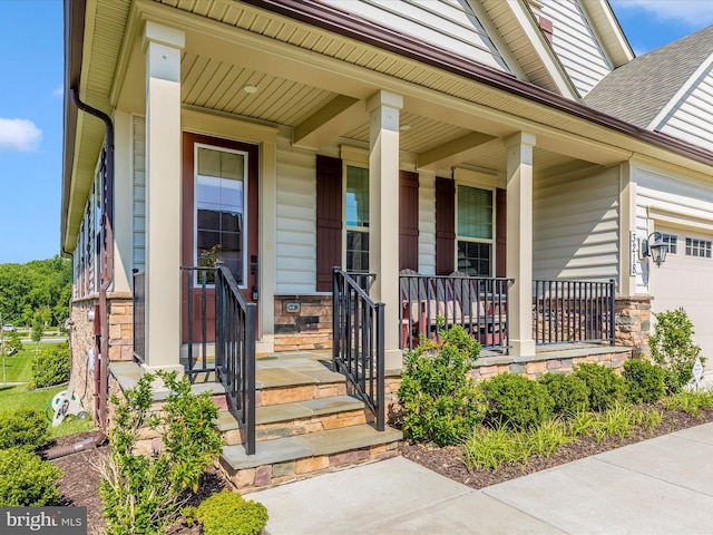 3218 Thornapple Dr, Frederick, MD 21704 - property entrance featuring covered porch, roof with shingles, stone siding, and an attached garage