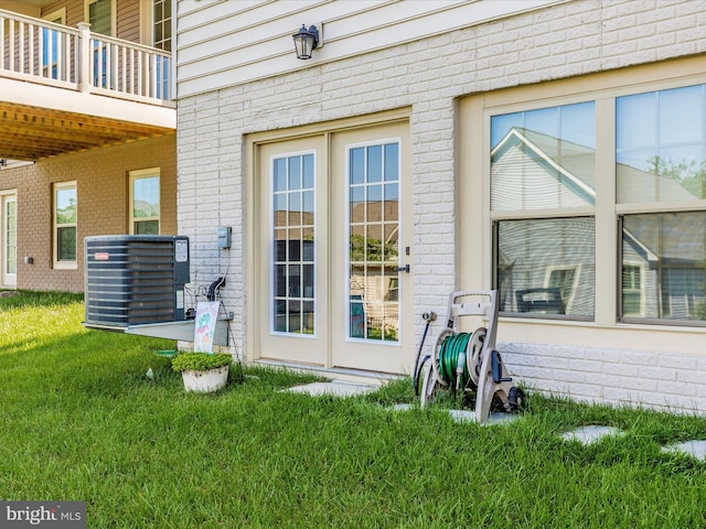 3218 Thornapple Dr, Frederick, MD 21704 - property entrance with central AC unit, brick siding, and a lawn