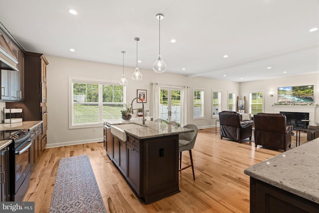 1413 Cortez Rd, Blue Bell, PA 19422 - kitchen with a sink, appliances with stainless steel finishes, a kitchen breakfast bar, baseboards, and light wood-style floors