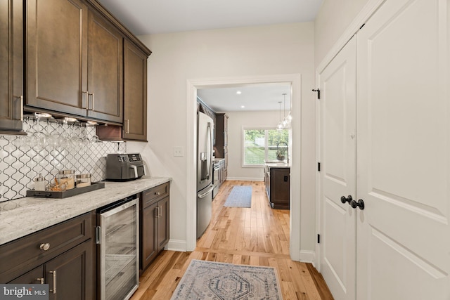 1413 Cortez Rd, Blue Bell, PA 19422 - kitchen with beverage cooler, light wood-style flooring, dark brown cabinetry, stainless steel refrigerator with ice dispenser, and recessed lighting