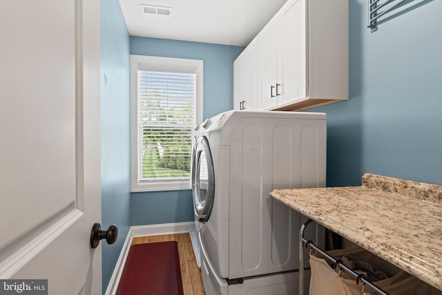1413 Cortez Rd, Blue Bell, PA 19422 - washroom with washing machine and dryer, cabinet space, wood finished floors, and baseboards