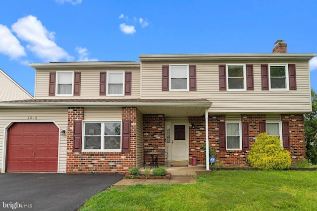 3618 Creamery Rd, Bensalem, PA 19020 - townhome / multi-family property featuring brick siding, a front yard, driveway, and a chimney
