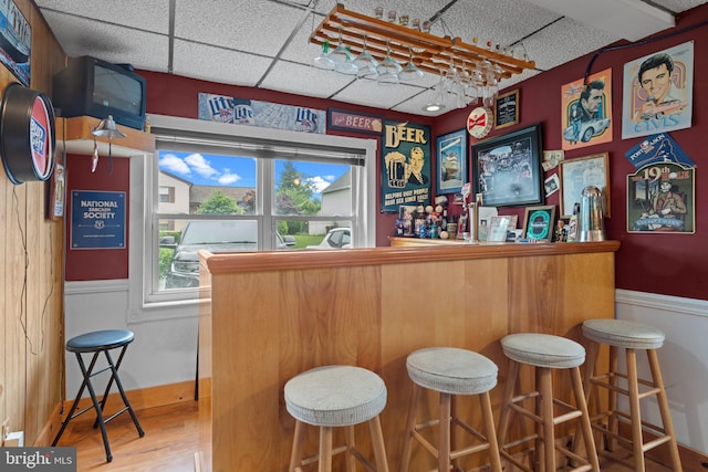 3618 Creamery Rd, Bensalem, PA 19020 - indoor dry bar featuring a paneled ceiling, a wainscoted wall, and wood finished floors