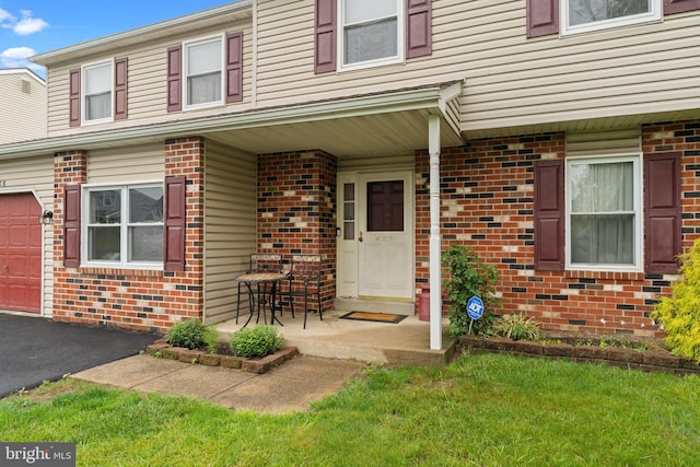 3618 Creamery Rd, Bensalem, PA 19020 - property entrance featuring brick siding, a porch, a lawn, driveway, and a garage