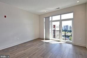 575 S Goddard Blvd Unit 511, King Of Prussia, PA 19406 - unfurnished room featuring plenty of natural light, baseboards, and wood finished floors