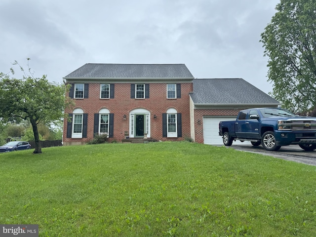 801 Irenic Ct, Norristown, PA 19403 - colonial house featuring an attached garage, a front yard, a shingled roof, brick siding, and asphalt driveway