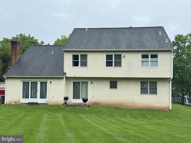 801 Irenic Ct, Norristown, PA 19403 - rear view of house featuring a chimney, stucco siding, a yard, and roof with shingles