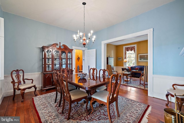 55 The Strand, New Castle, DE 19720 - dining space featuring dark wood-style floors, wainscoting, and a chandelier
