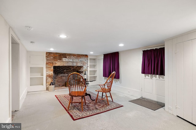 55 The Strand, New Castle, DE 19720 - living area featuring built in shelves, a fireplace, finished concrete flooring, recessed lighting, and baseboards