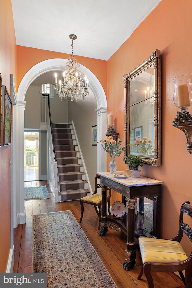 55 The Strand, New Castle, DE 19720 - foyer entrance featuring arched walkways, hardwood / wood-style floors, a chandelier, stairway, and ornate columns