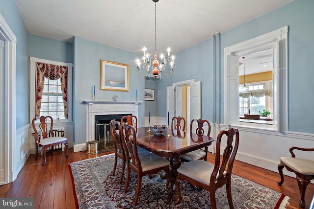 55 The Strand, New Castle, DE 19720 - dining room with dark wood finished floors, a chandelier, and a fireplace