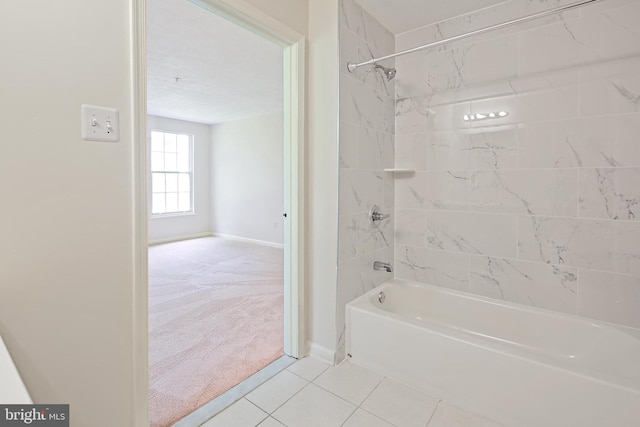bathroom featuring baseboards, tub / shower combination, and tile patterned floors