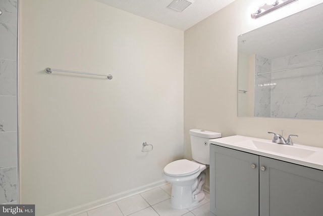 bathroom with tile patterned flooring, toilet, vanity, a shower, and baseboards